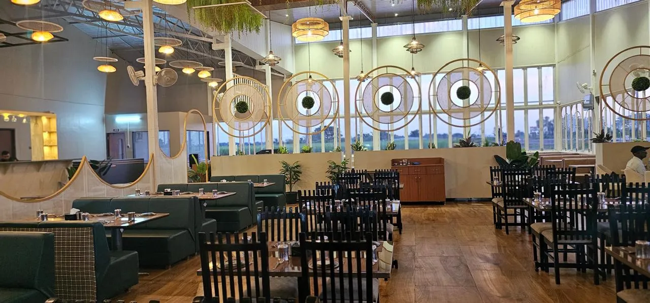 Spacious dining hall with cane pendant lights and field-view windows